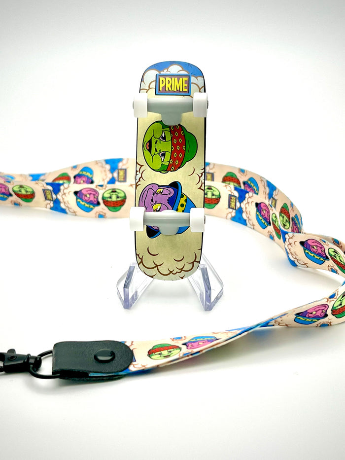 Art Decks - In Prime We Trust skateboard with cartoon characters, lanyard, and connector on stand.