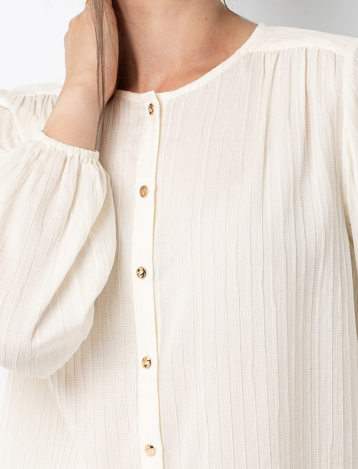 Blouse texturée à boutons dorés