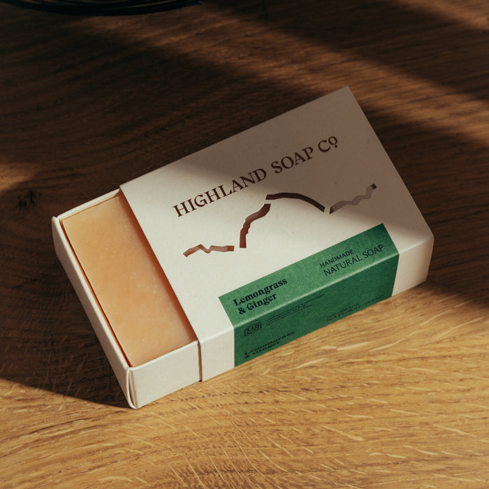 Highland Soap Co. bar of soap in packaging on a wooden surface