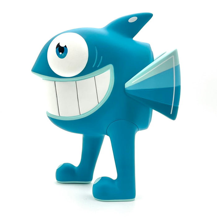 A vinyl figure of a cartoon fish toy with big eyes and a massive smile, inspired by street art legend Pez's iconic character.